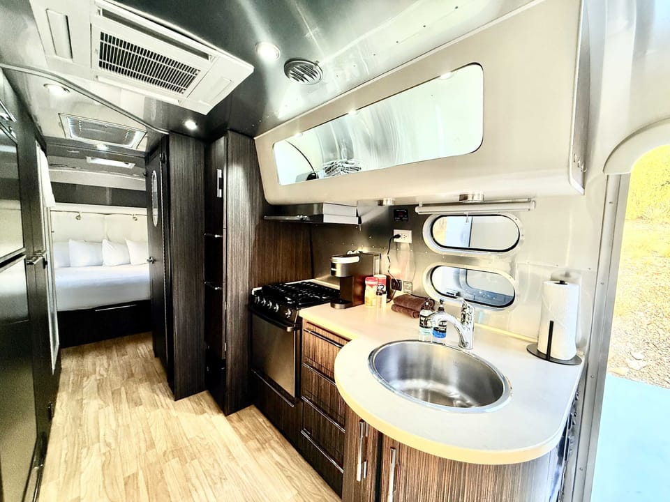 Airstream kitchen area with convenient essentials for simple meals, snacks, and morning coffee during your Southern Utah glamping stay.