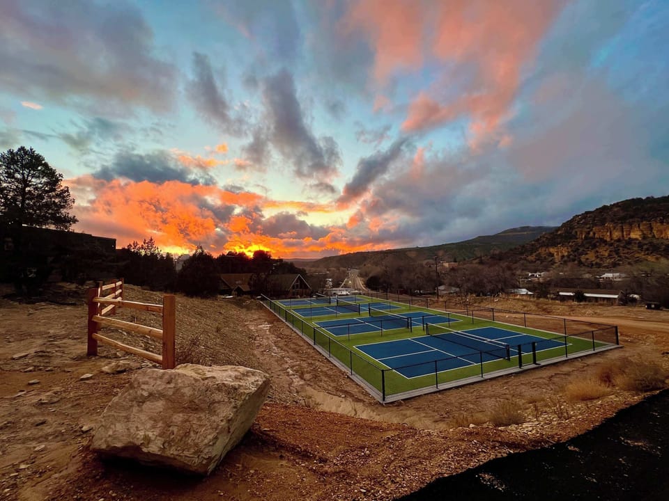 Enjoy sunset pickleball just a short walk from your Airstream glamping unit during your Southern Utah stay near Zion National Park and Bryce Canyon.