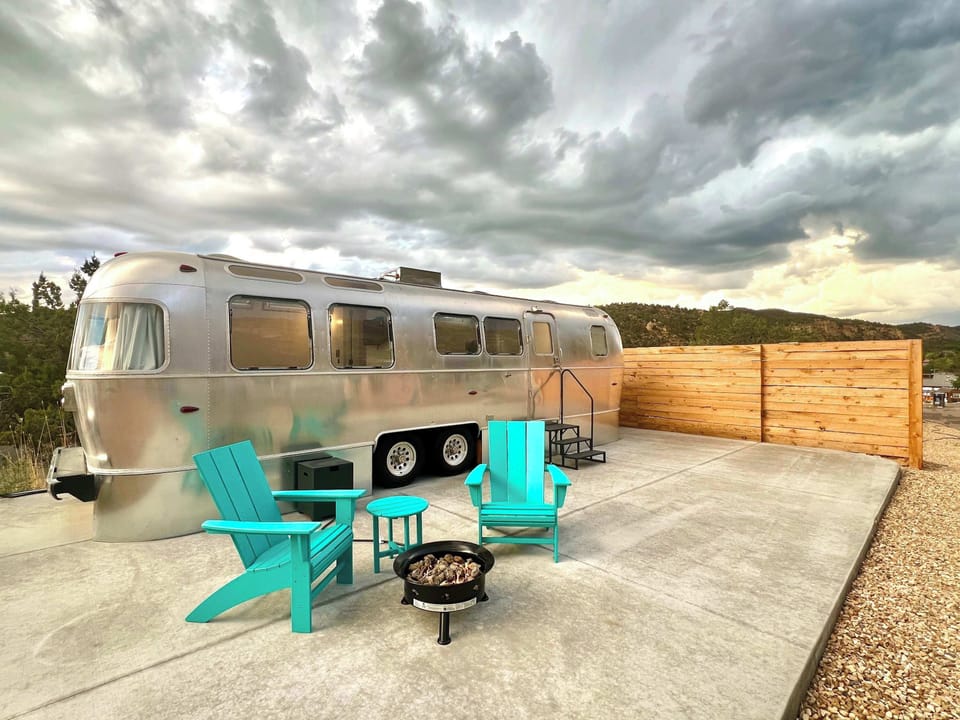 Airstream Legacy includes private outdoor seating and a fire pit, creating the perfect cozy spot to unwind after a day of adventure.