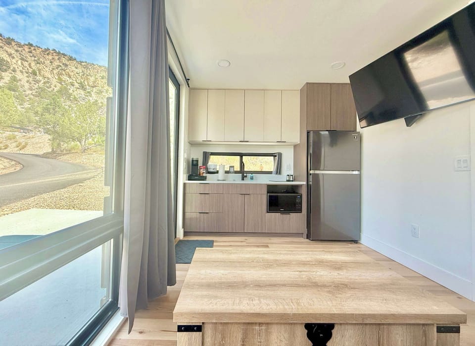 Enjoy blue sky and mountain views from the cabin’s living area and kitchen, creating a bright and peaceful space to relax during your Southern Utah stay.  