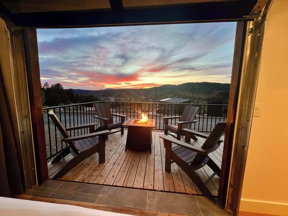 Sunset views from bed with your private deck, fire pit, and Southern Utah scenery just outside your door.