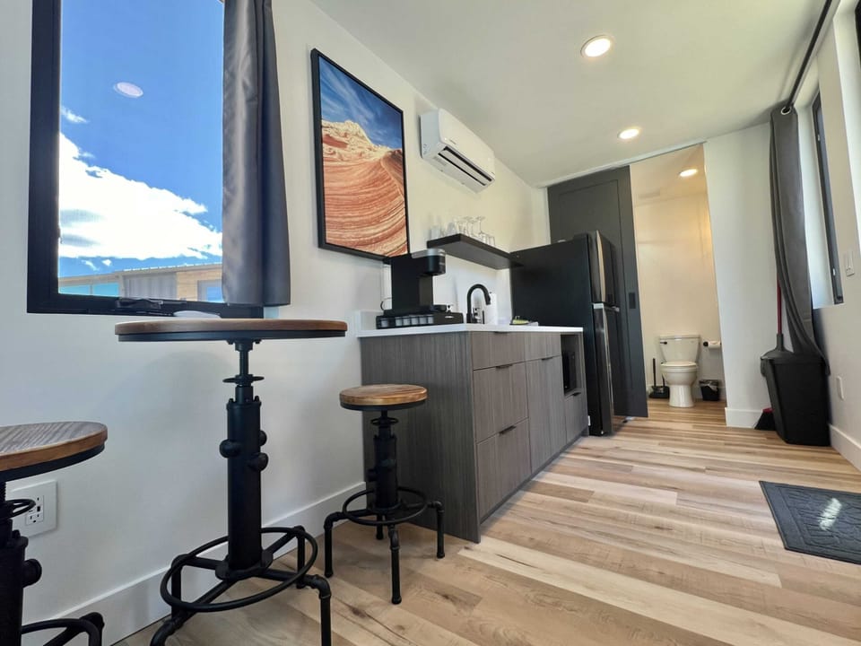 Luxury kitchenette with a large refrigerator, cooking utensils, and essentials for preparing simple meals during your Southern Utah cabin stay.