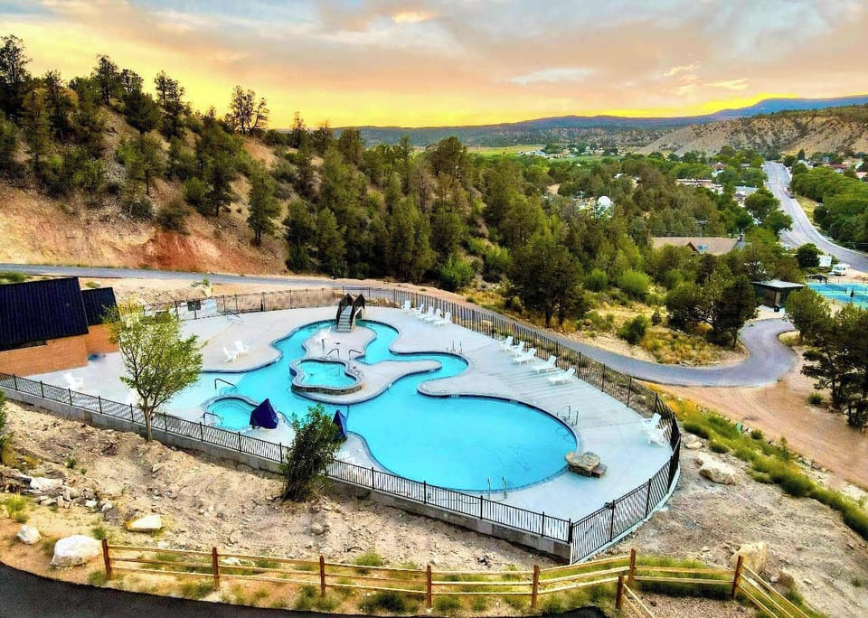Upper pool area with a lazy river, two hot tubs, and beautiful valley views — a perfect place to relax after a day exploring Southern Utah.