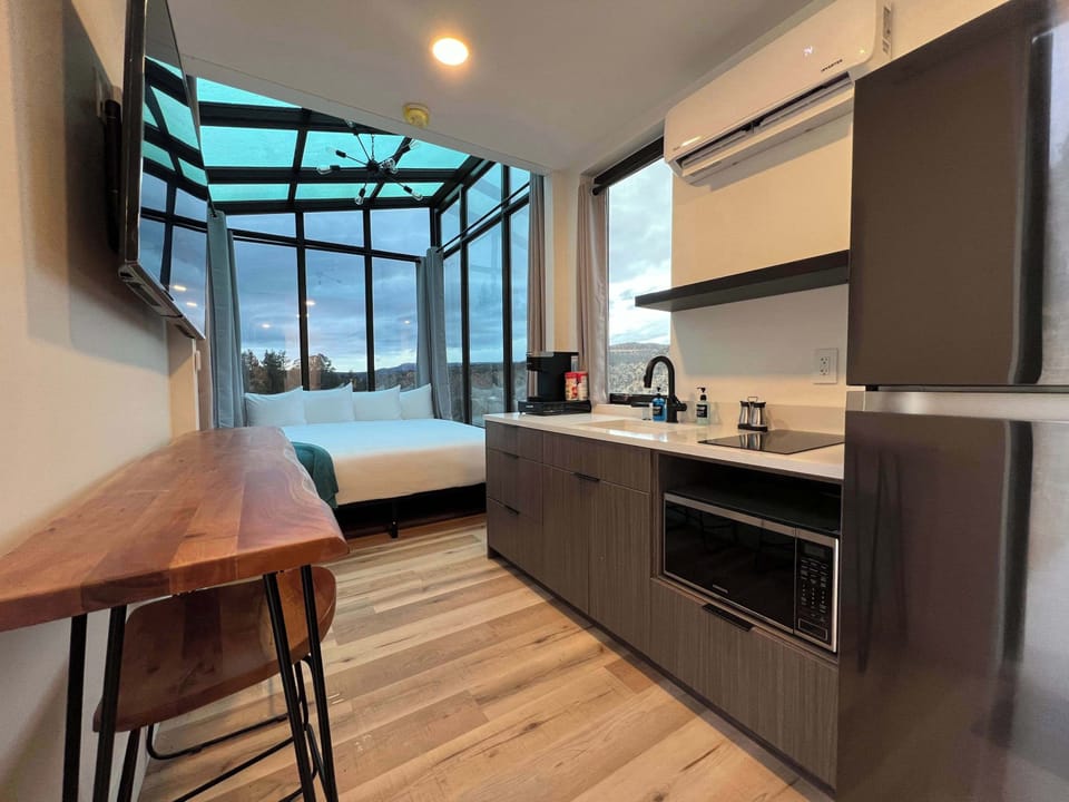 Full kitchen area inside Wild Sage with a refrigerator, cooking essentials, and everything you need for easy meals during your Southern Utah stay.