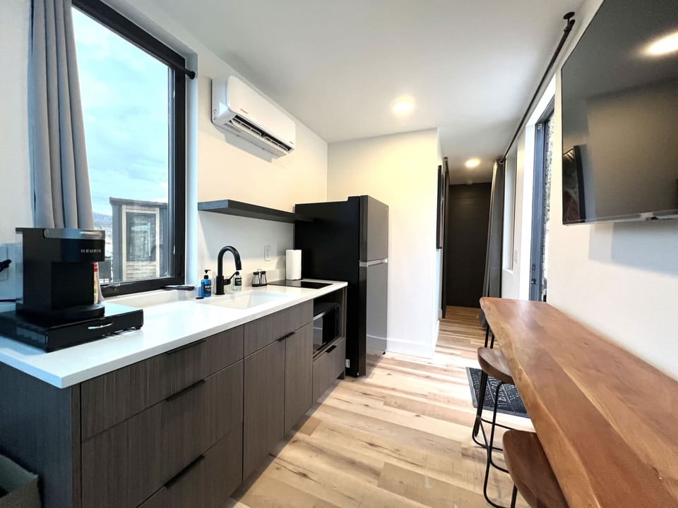 Full kitchen area inside Wild Sage with a refrigerator, cooking essentials, and everything you need for easy meals during your Southern Utah stay.