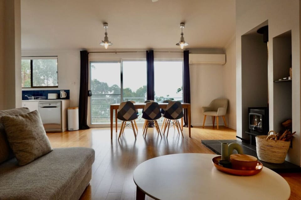 Open plan dining and living leading out to expansive deck and views