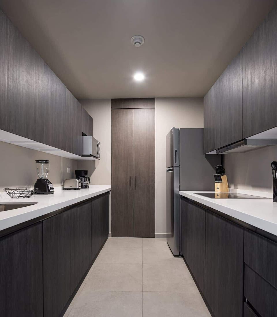 Fully equipped kitchen with modern appliances, ready for home-cooked meals.
