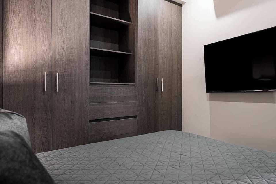 Bedroom 2 with a queen-size bed and ample storage.