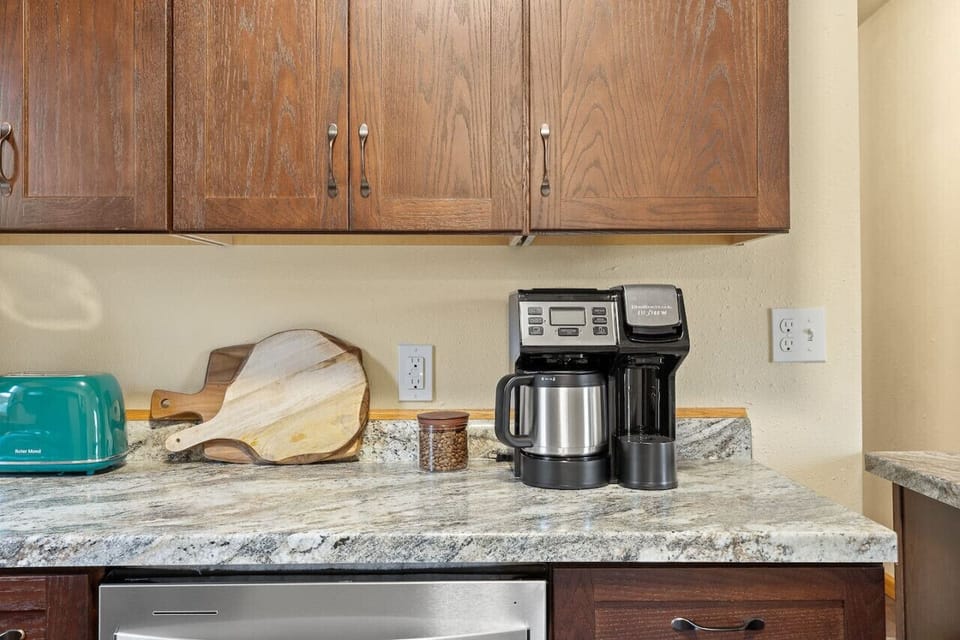 The sleek coffee maker brews rich, aromatic coffee with just the touch of a button, making mornings feel effortlessly indulgent.