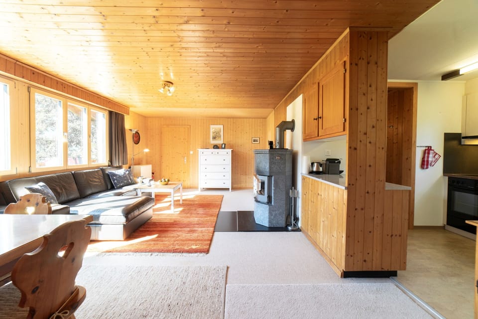 Living area with fireplace and open kitchen