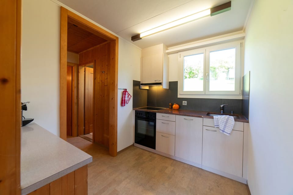 Bright, practical kitchen with window and ample worktop space
