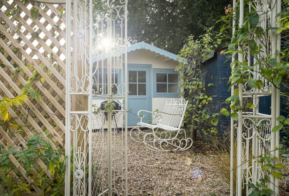 The garden features a pretty summer house and charcoal barbecue, perfect for sunny days