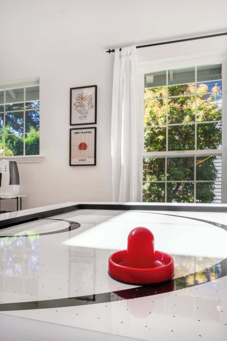 Modern air hockey table with a close-up of the game, perfect for family fun or a friendly challenge.