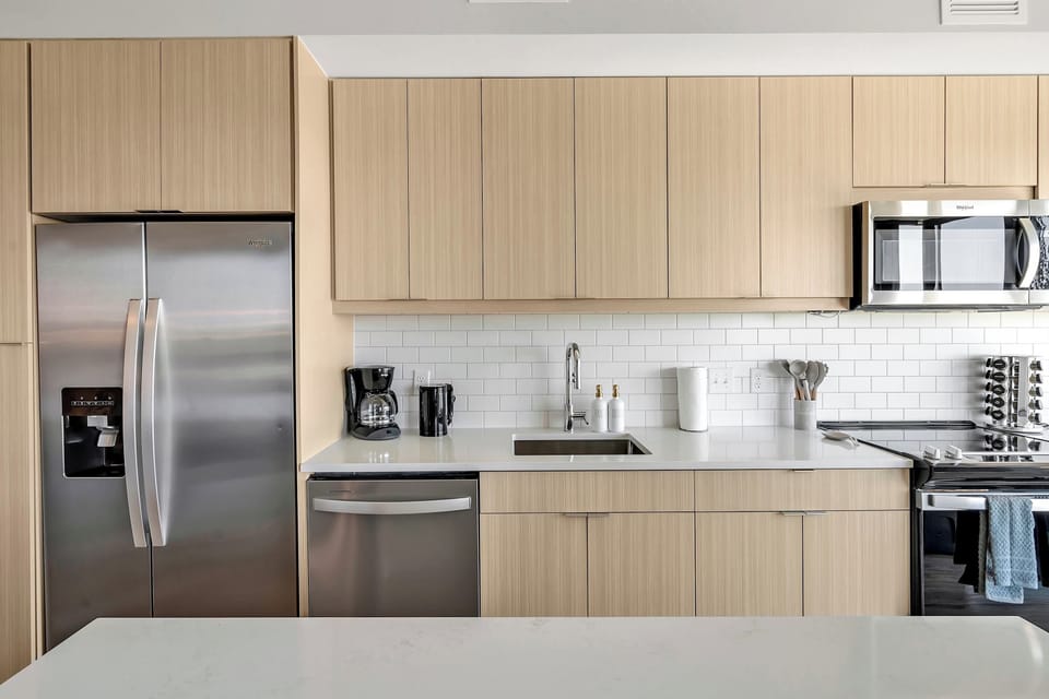 Kitchen with cooking essentials including microwave, oven, ice machine, dishwasher