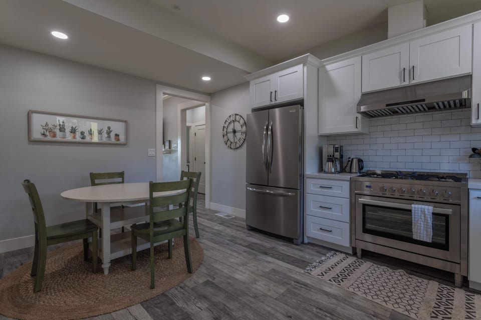 Gather around the charming vintage dining table in this light and airy kitchen—perfect for meals and memories.