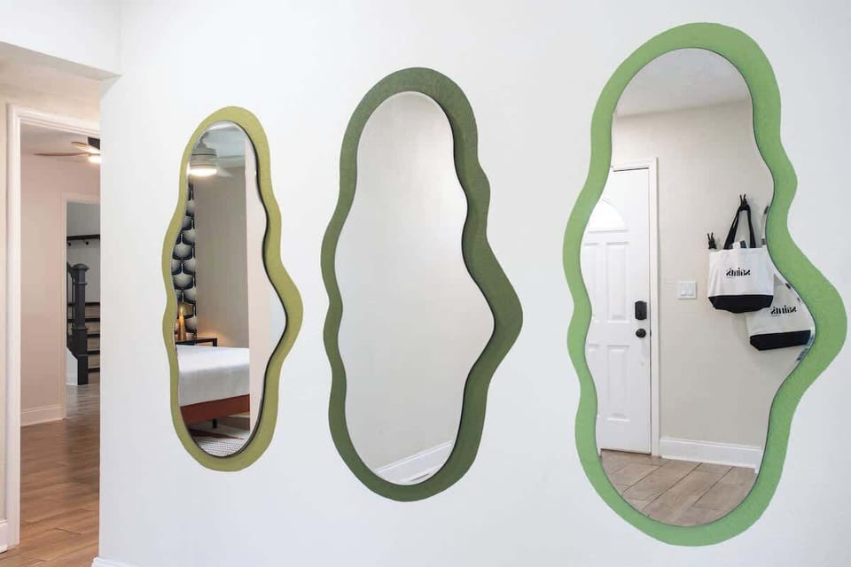 With three stunning mirrors that add depth and light, this living room is both inviting and chic—a perfect backdrop for relaxation and gatherings.