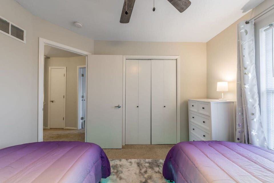 A vibrant kids` room with two comfy single beds, playful décor, and soft underbed lighting that creates a magical glow. This cheerful space blends fun and function, offering the perfect spot for little ones to dream, play, and relax.