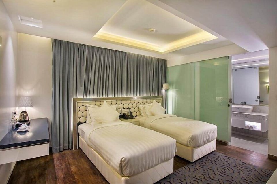 Deluxe Twin Room, City View | In-room safe, desk, laptop workspace, blackout drapes