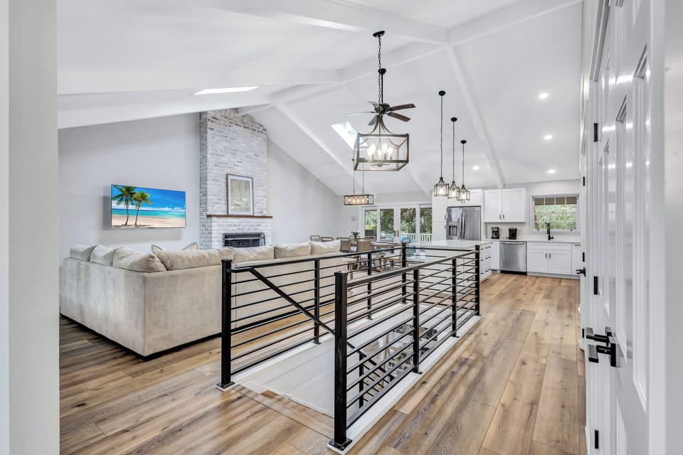 Spacious living area with vaulted ceilings and large deck access