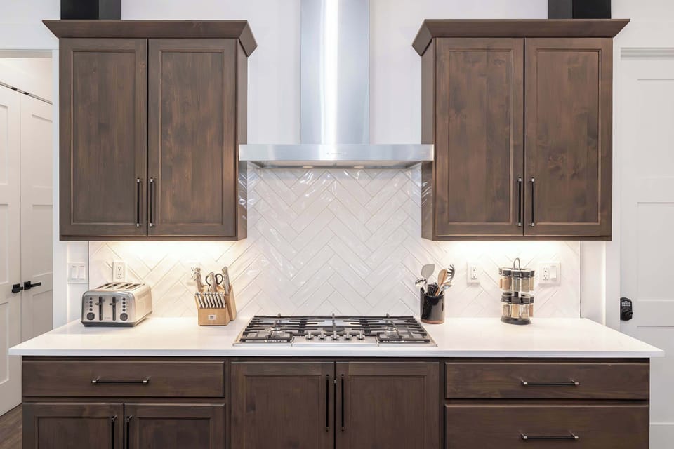 - Modern kitchen setup with a gas range, sleek backsplash, and ample cabinet storage. Perfect for home-cooked meals with everything you need within reach.
