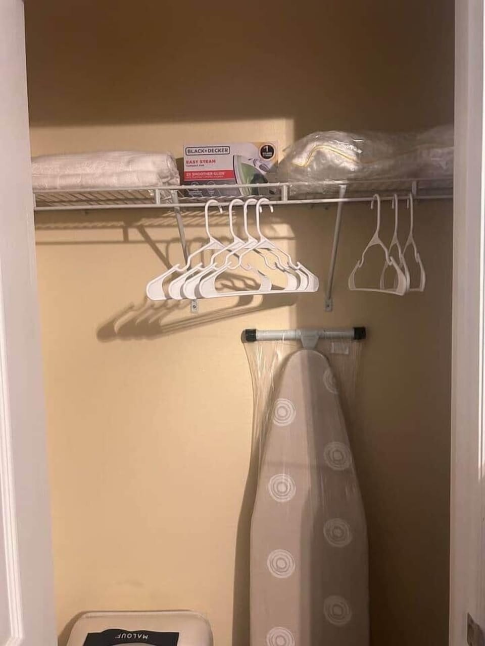 "We've stocked the main bedroom downstairs with everything you need for a relaxing stay, including an iron and ironing board, extra cozy bedding, and plenty of towels and hangers. Feel free to make yourself at home!"