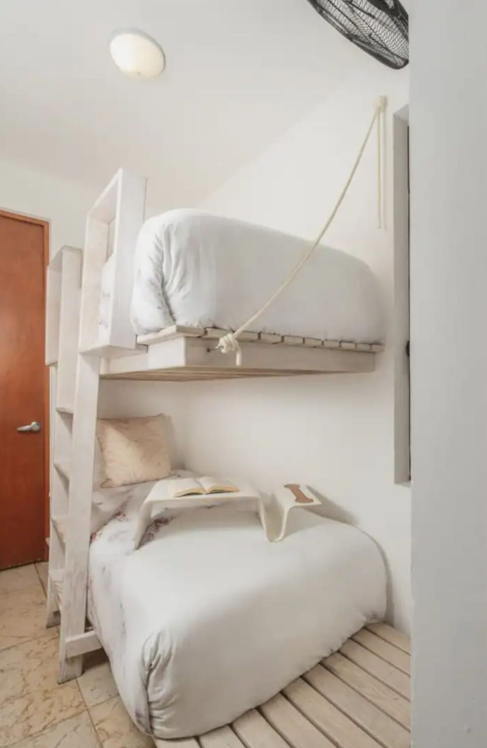 Minimalist bedroom featuring a bunk bed, perfect for children and NO AC.