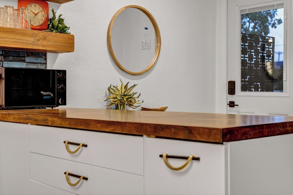 Gorgeous butcher block counters and entry door with built in privacy shades.