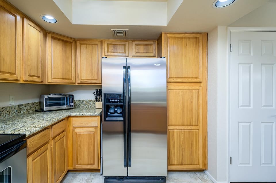Stainless Steel refrigerator with ice maker.