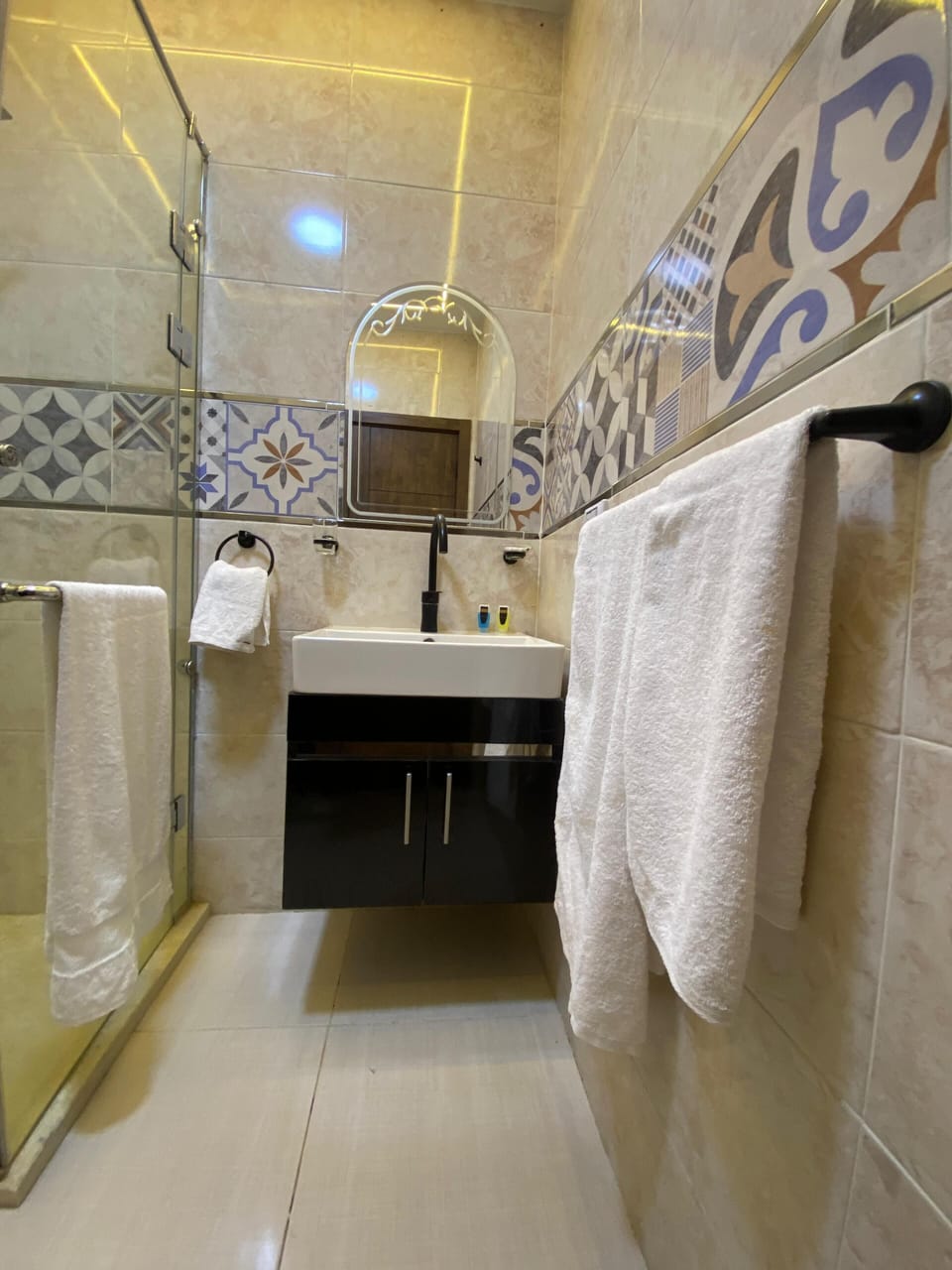 Shower, rainfall showerhead, designer toiletries, hair dryer