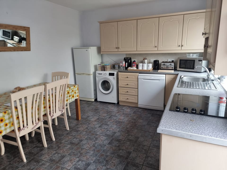 Large  kitchen ,fully kitted out with all appliances  including  washing machine, dishwasher, dryer, fridge, microwave, toaster, air fryer, utensils etc
