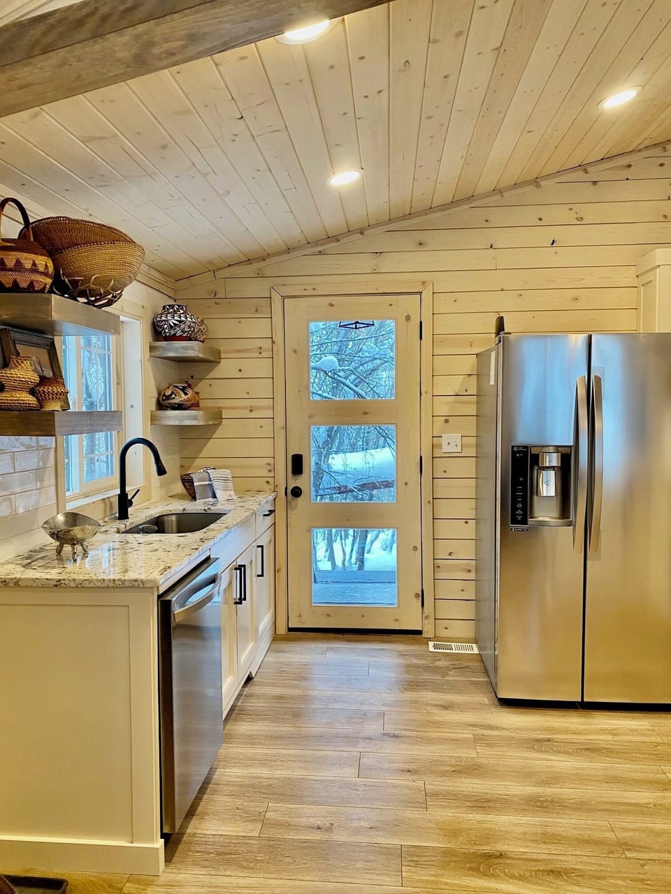 A full kitchen with granite waterfall peninsula with extra seating and gas range