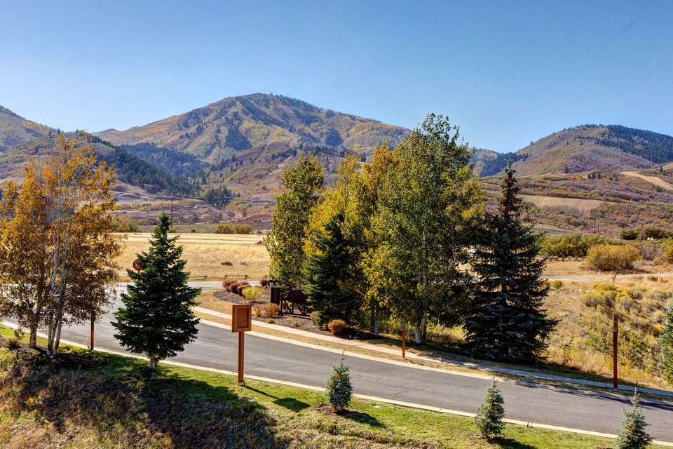 Stunning mountain scenery and autumn foliage frame the property's natural surroundings, with expansive valley views stretching toward forested peaks.