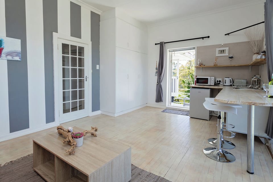 Superior Apartment, Ocean View | Living area | 43-inch Smart TV with digital channels, books