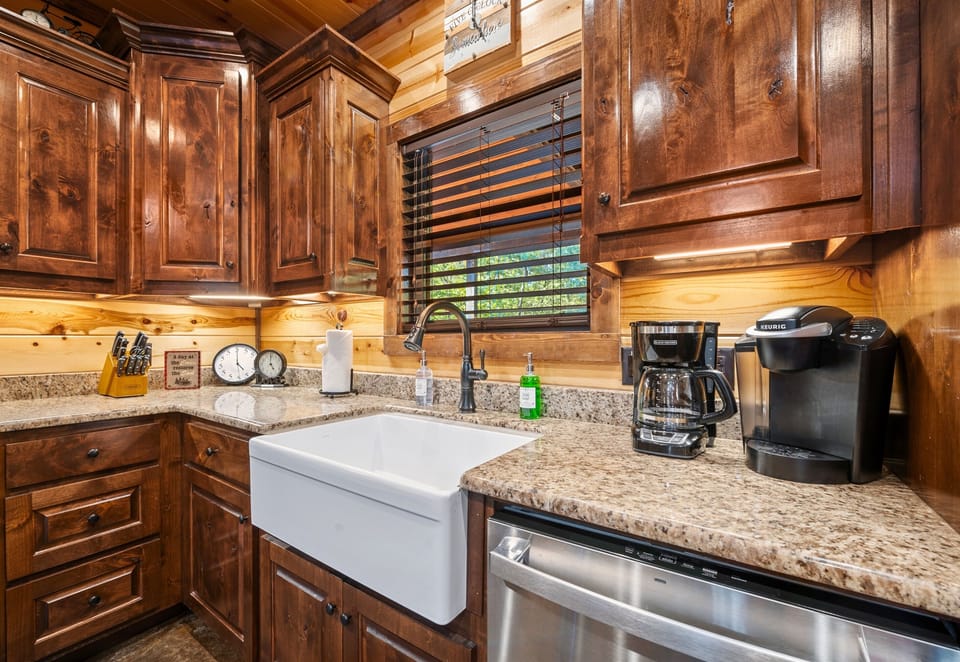 Clean-up is easy with this farmhouse sink, while the ample counter space and storage make cooking here a delight. It’s a kitchen designed for convenience and style.