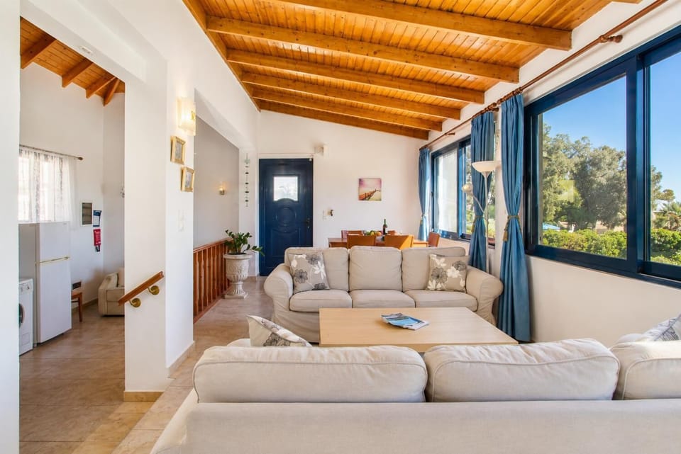 Open-plan living room with sofa, dining area, kitchen, WiFi internet, and satellite TV