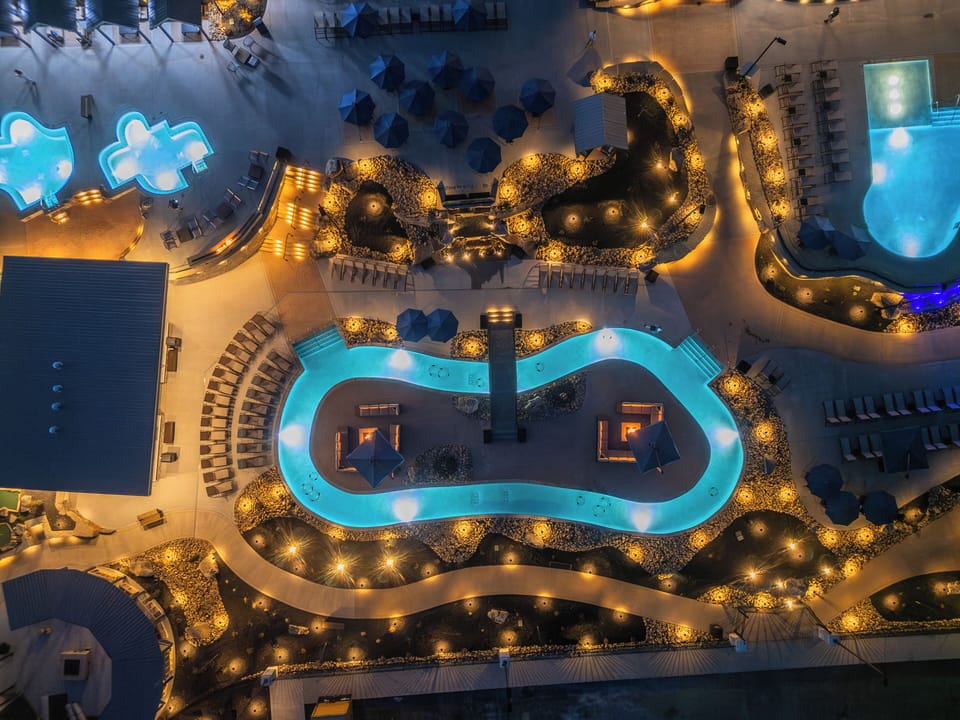 Resort-style outdoor pool and lazy river with beautiful aerial views