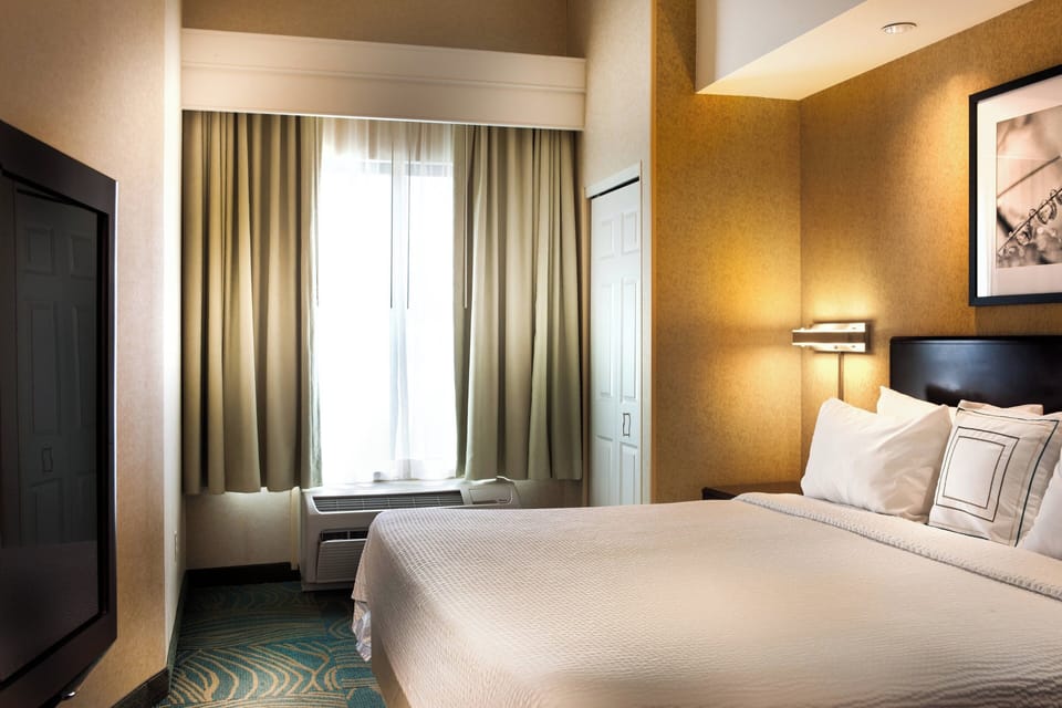 Premium bedding, desk, laptop workspace, blackout drapes