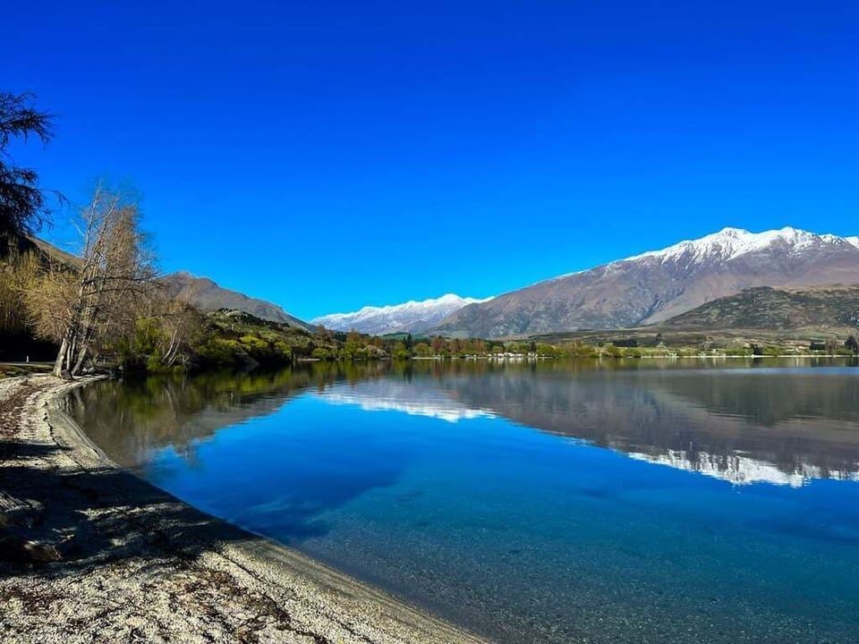 Just 8 minutes away, Lake Wānaka from the shores of Glendhu Bay — still, glassy and breathtaking in the winter light