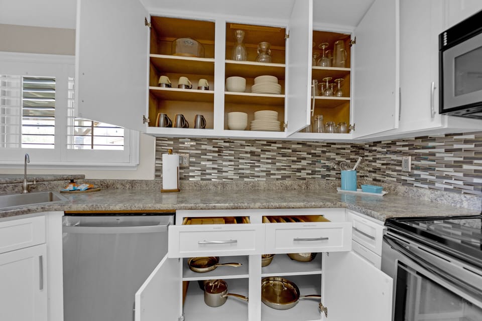 The main level features sleek stainless steel appliances, and expansive countertops, making meal prep a joy.
