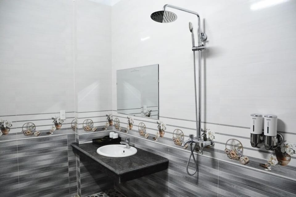 Shower, hair dryer, slippers, towels