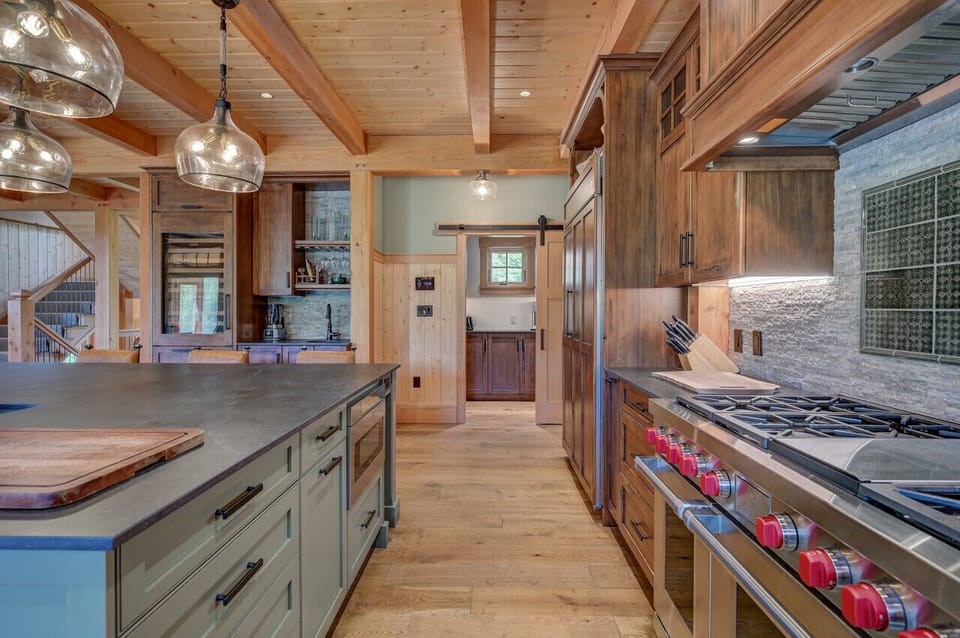 A chef’s gourmet kitchen with an open floor plan and high-end commercial appliances, perfect for cooking and entertaining.