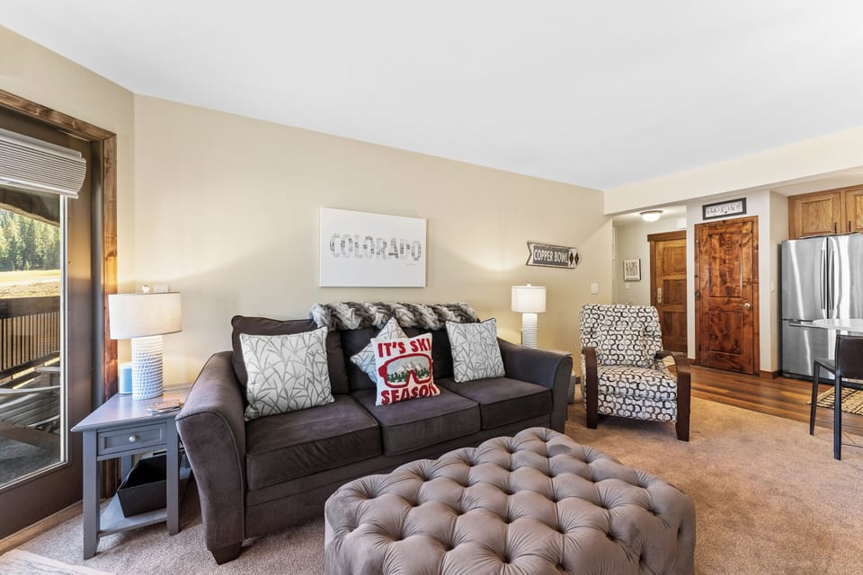 Living area featuring a queen size sleeper sofa, gas fireplace, and flat-screen TV