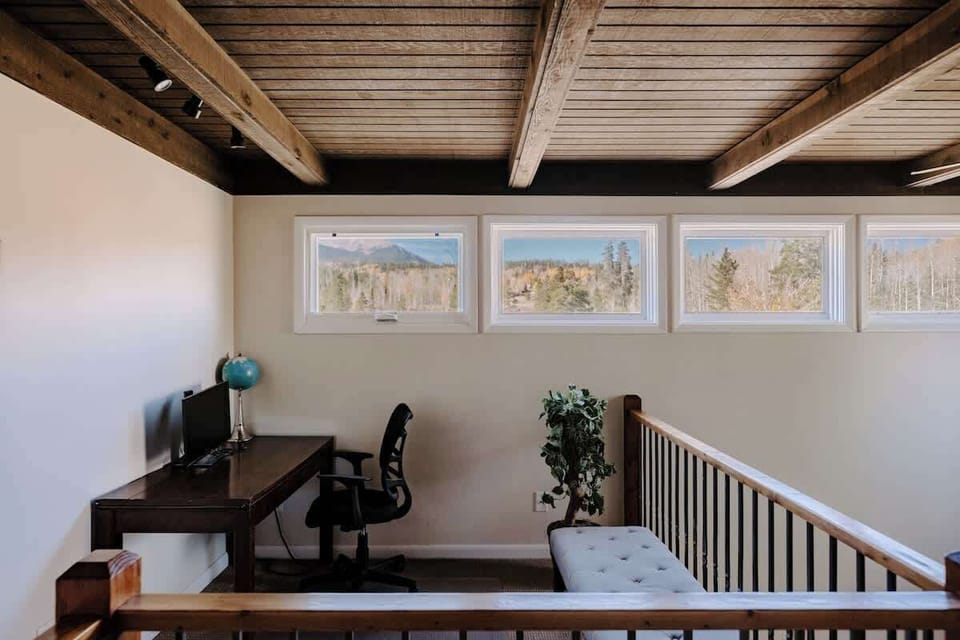 2nd story landing has a desk, chair, and monitor