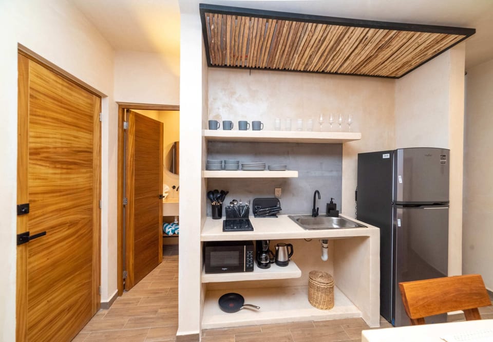 a bedroom with bed and table in Tulum apartment rentals