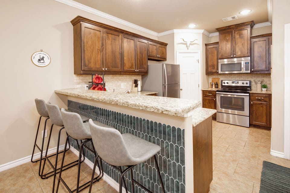 Kitchen with kitchen counter with bar seating for 4