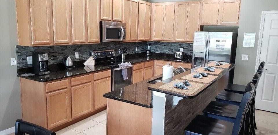Cook with ease in a spacious kitchen featuring sleek countertops and modern appliances.