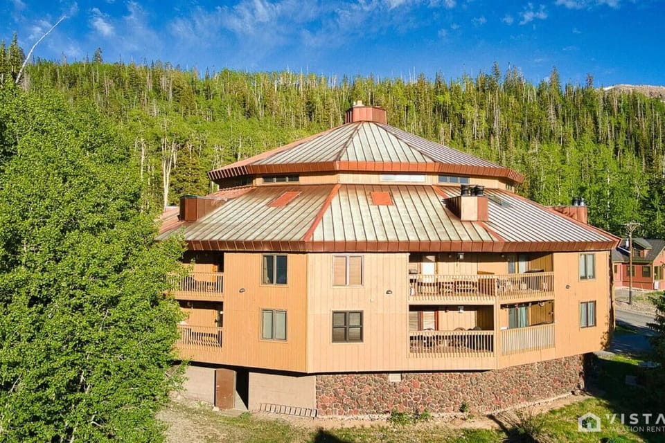 Experience breathtaking views of the Timbernest building, nestled in a picturesque setting that beautifully blends nature with modern design.