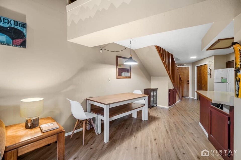 Enjoy the open-concept layout of Timbernest, where the living room, dining area, and fully equipped kitchen seamlessly flow together.