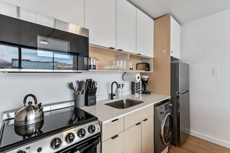 Modern kitchen w/ stove, fridge & clean lines for simple, functional cooking
