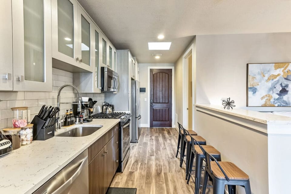 Galley kitchen w/ bar seating, long counters & plenty of storage space